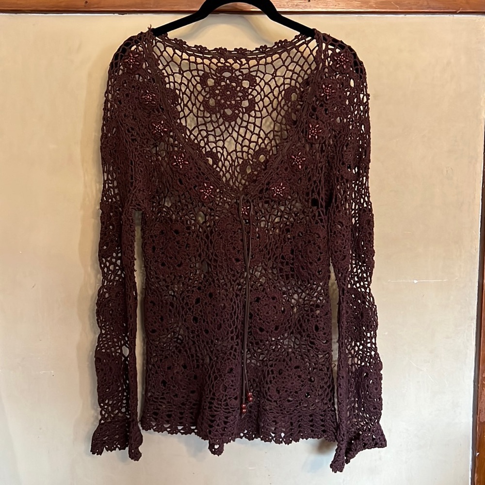 Beautiful brown long-sleeved crochet top with flower and bead details.